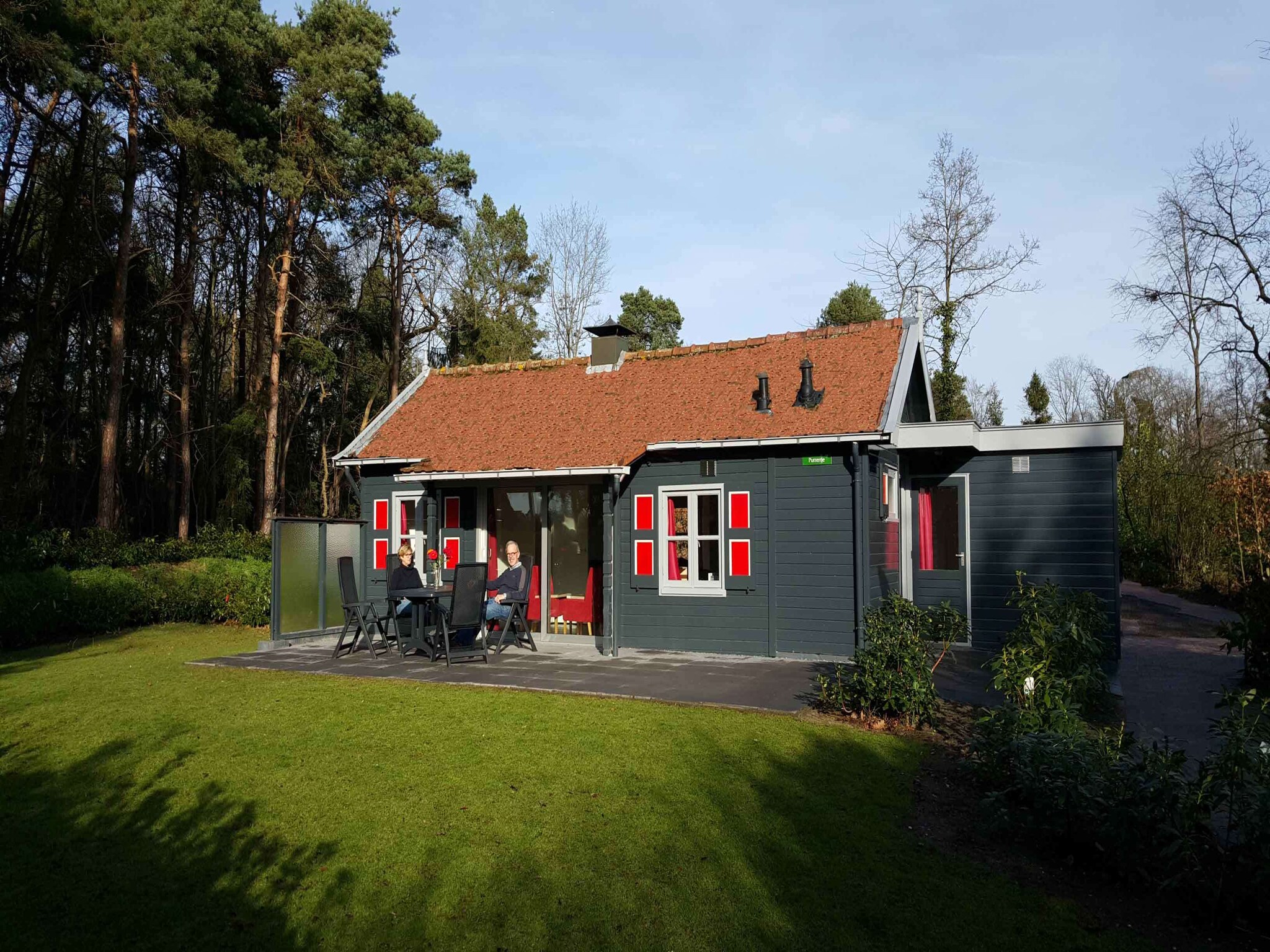 Nicely furnished bungalow with a fireplace and green area