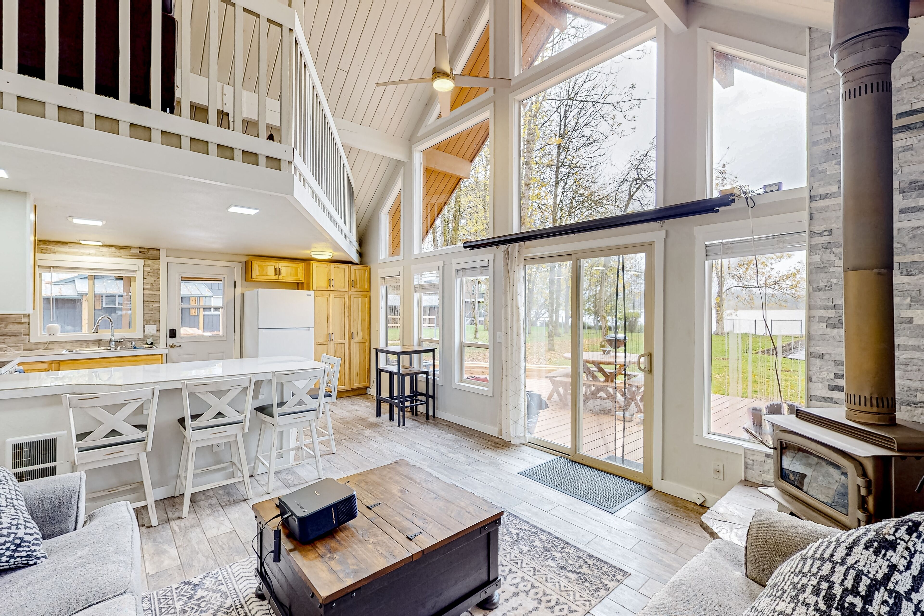 Peaceful lakeside home with wood-burning fireplace, patio, loft, & washer/dryer