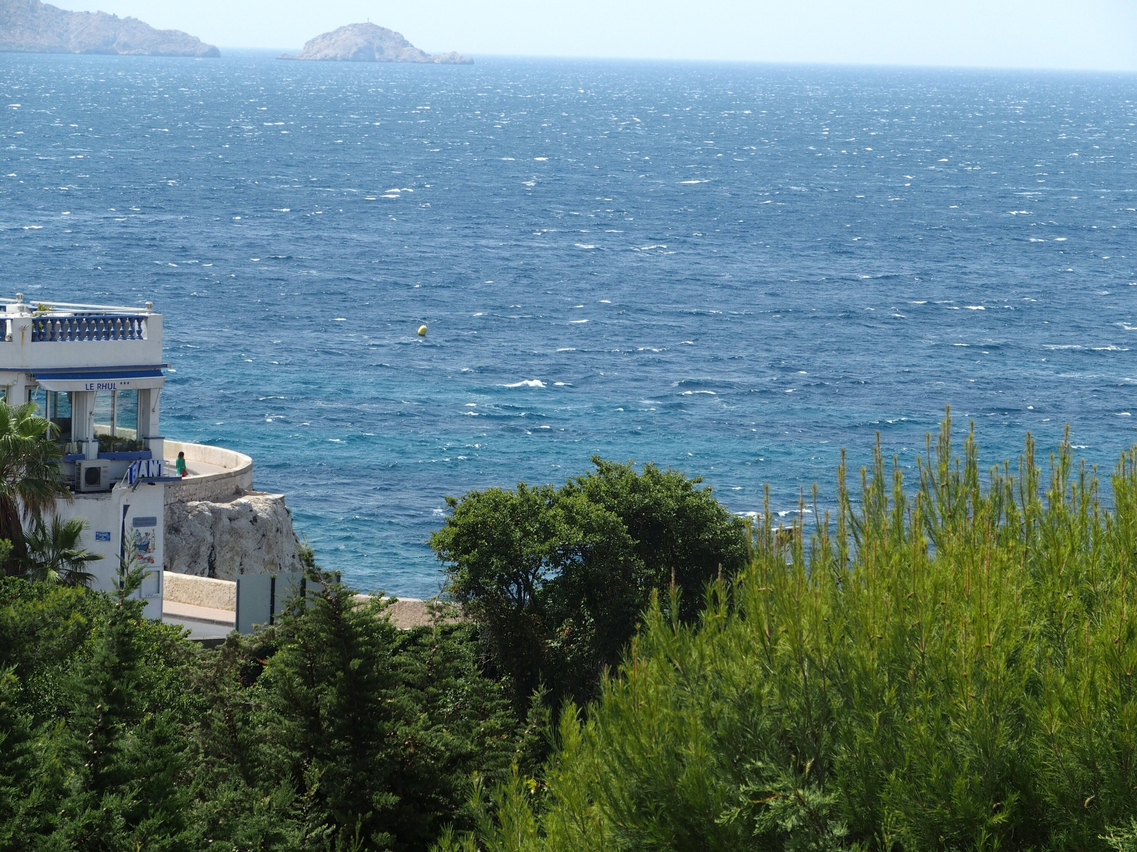 A balcony over the sea. A room in town