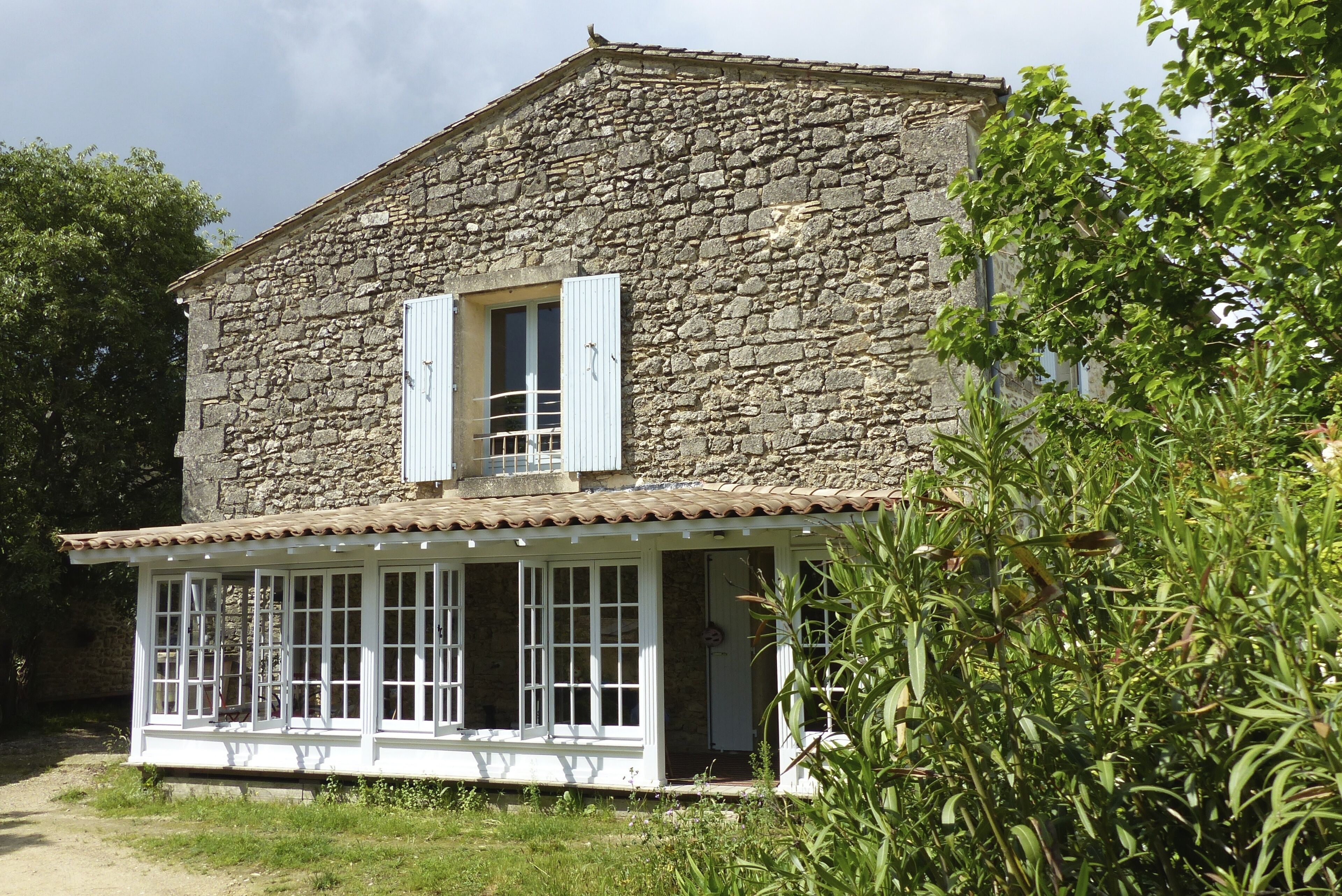 Superbly equipped apartment in old stone house with large pool and great view.