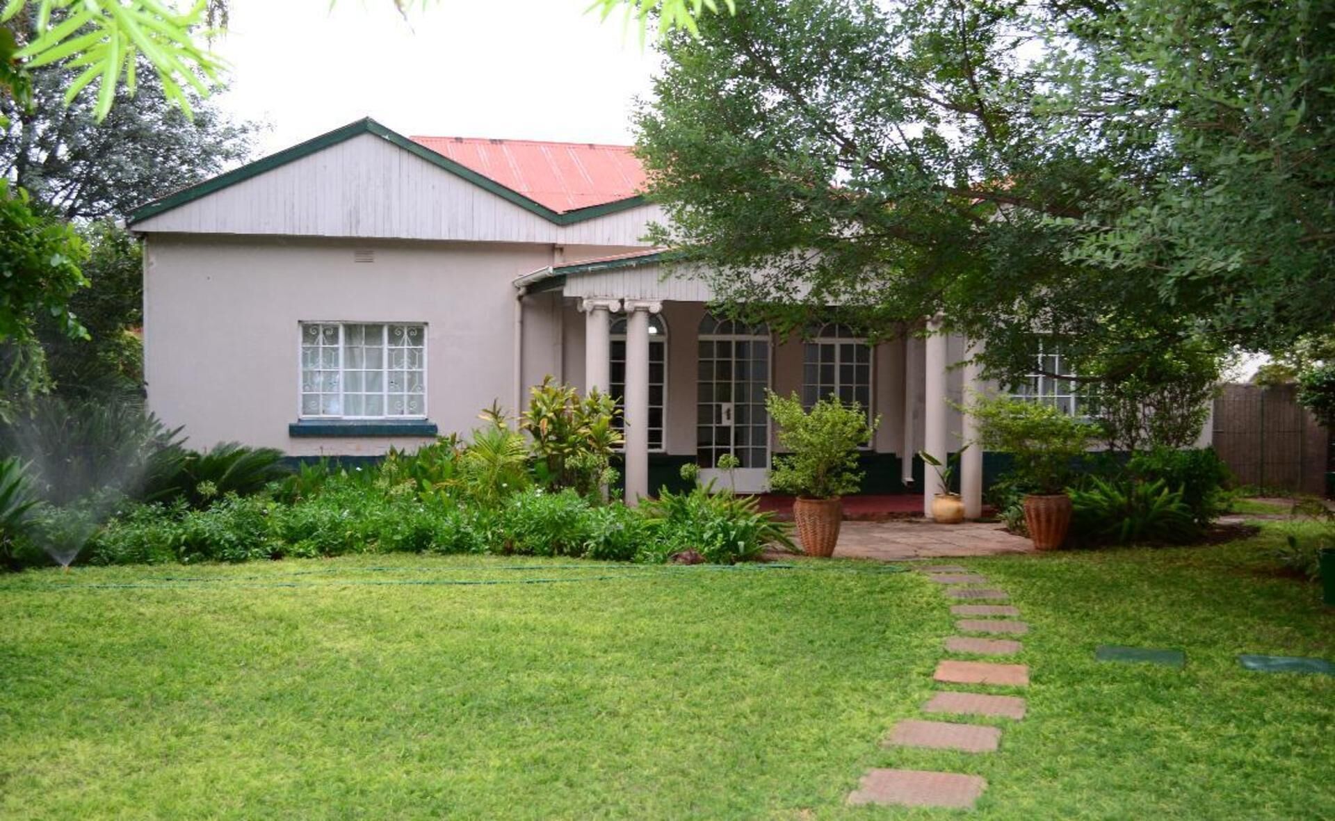 A beautiful spacious victorian house surrounded by a beautiful garden.