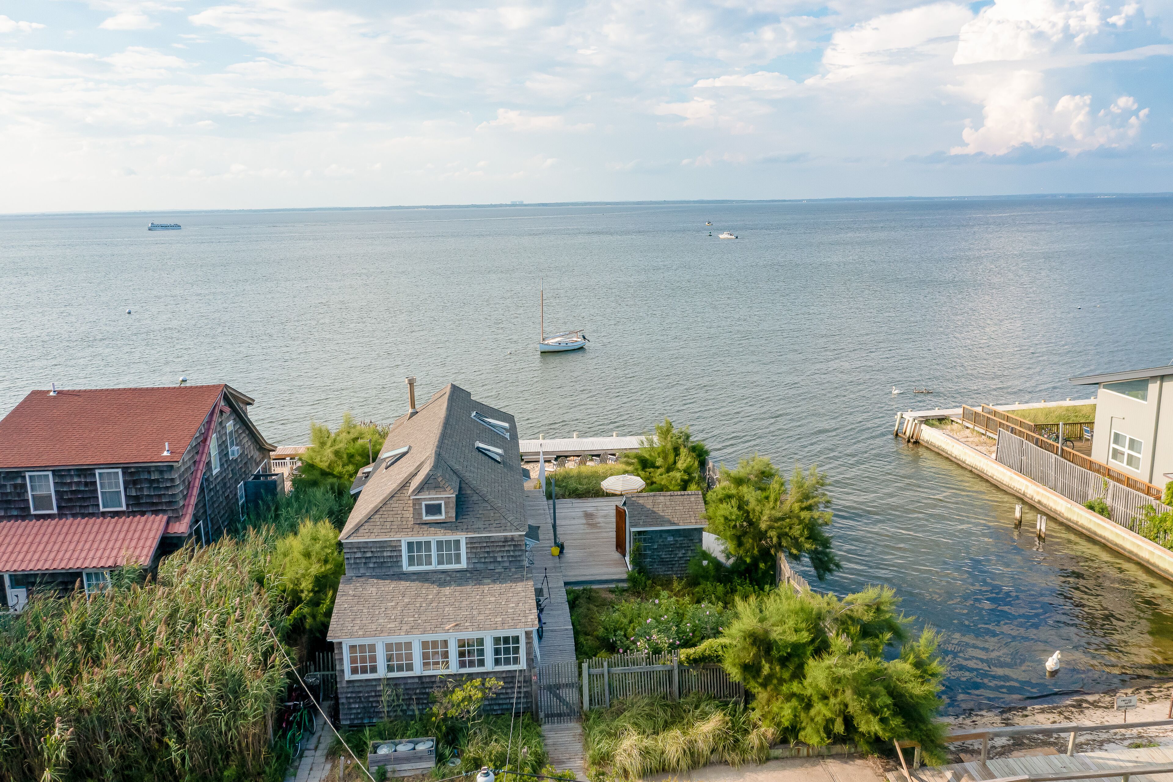 Bay-view apartment with deck, grill, enclosed porch, full kitchen, & WiFi
