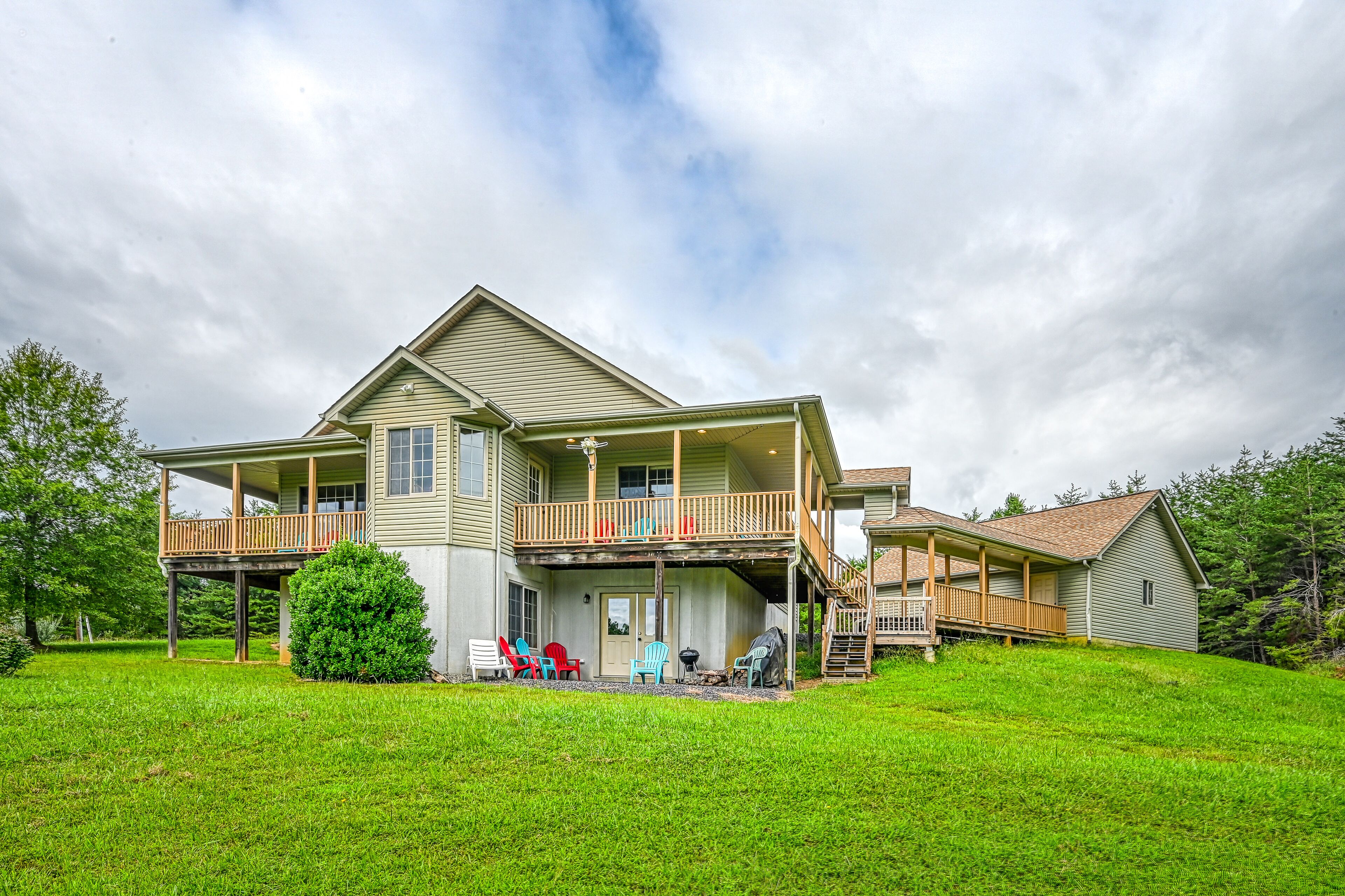 +4 acre lakefront retreat with private boat slip, wraparound porch, grill, & W/D